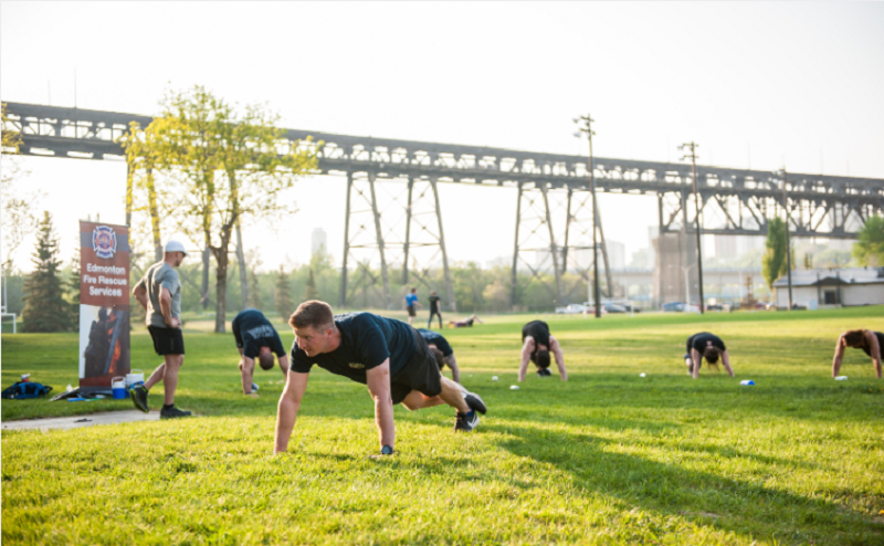 group of people holding planks in field