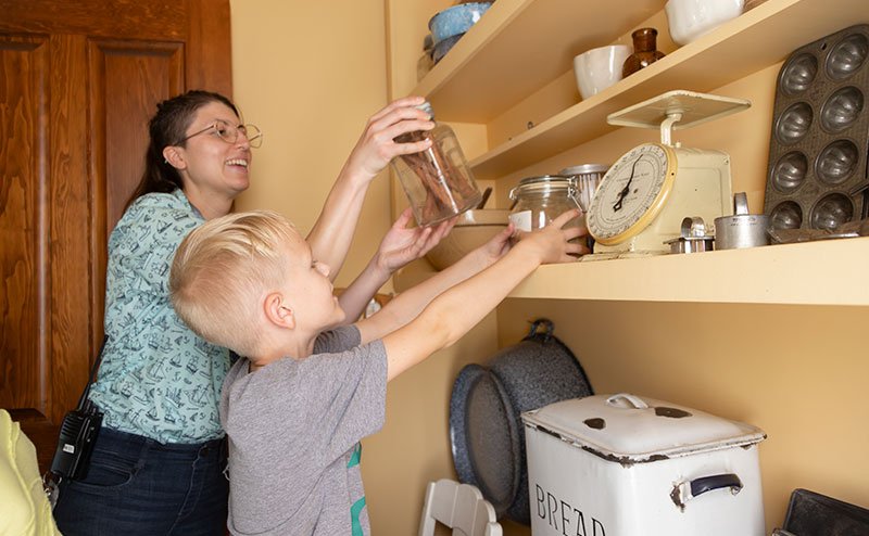 person and kid with baking supplies