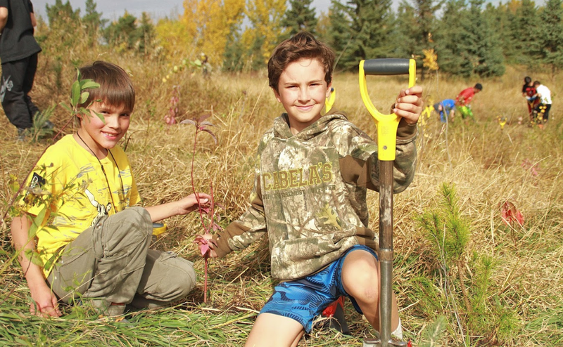 two persons in filed with shovel
