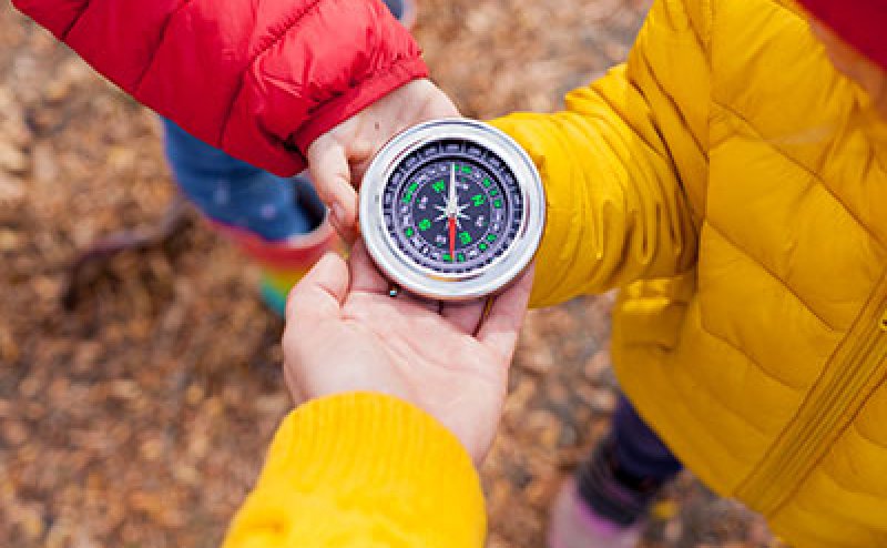 hands holding a compass