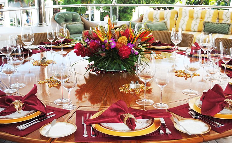 Expertly set table with full place settings and a large flower bouquet