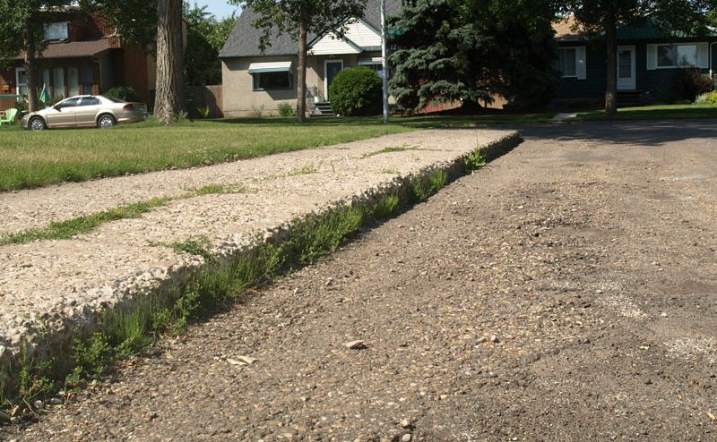 A closeup of a curb that needs to be replaced