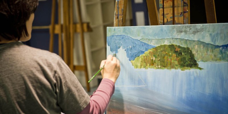 Woman painting on canvas