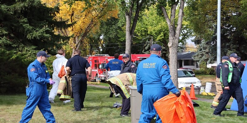 group of fire rescue staff cleaning up site
