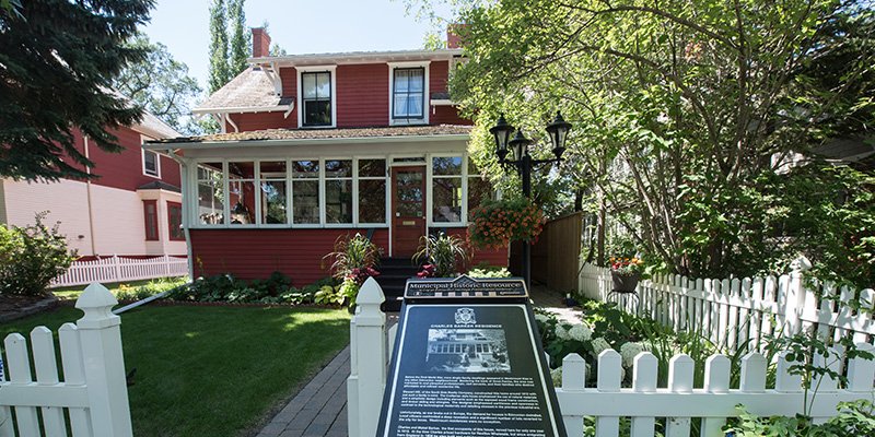 red house with white fence