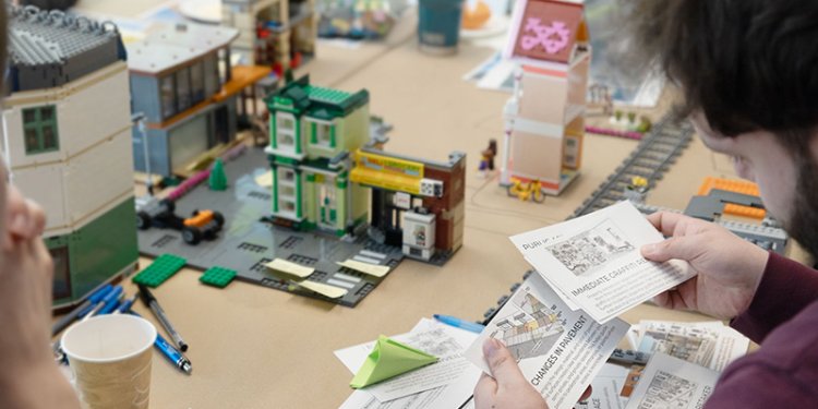 persons sitting at table with note cards