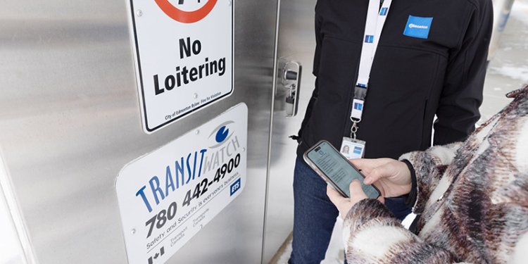 persons standing at door with cell phone